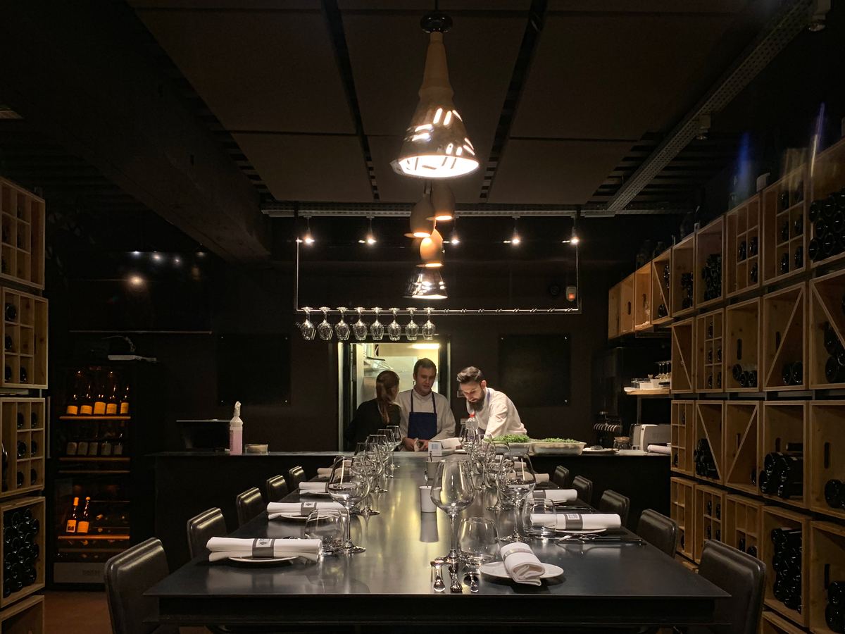 The back room: one long table lined with wine racks