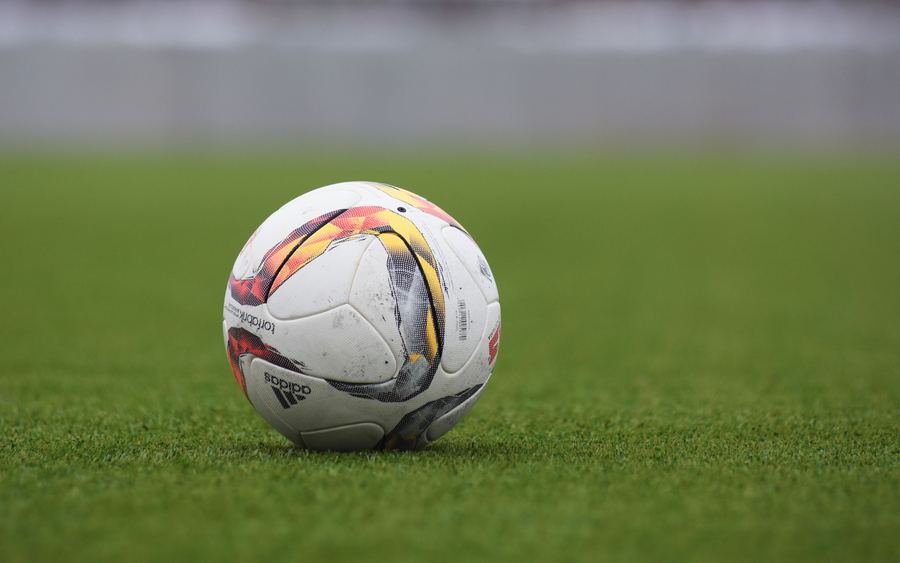 A match ball resting on the grass