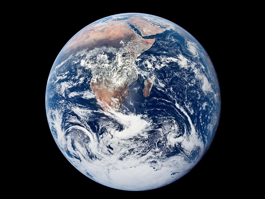 The whole Earth, fully lit, with Africa and Antarctica under swirling white cloud